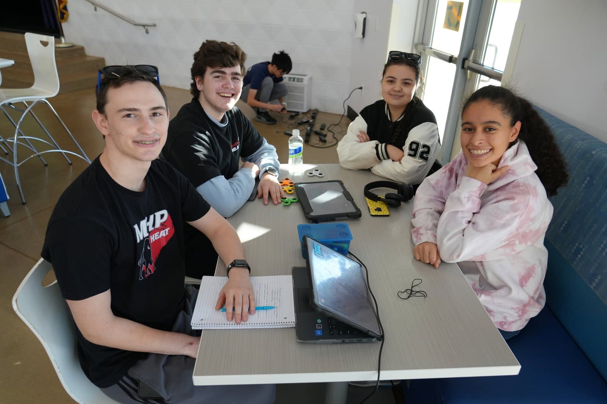 A Madison Highland Prep student testing a circuit at a classroom workstation