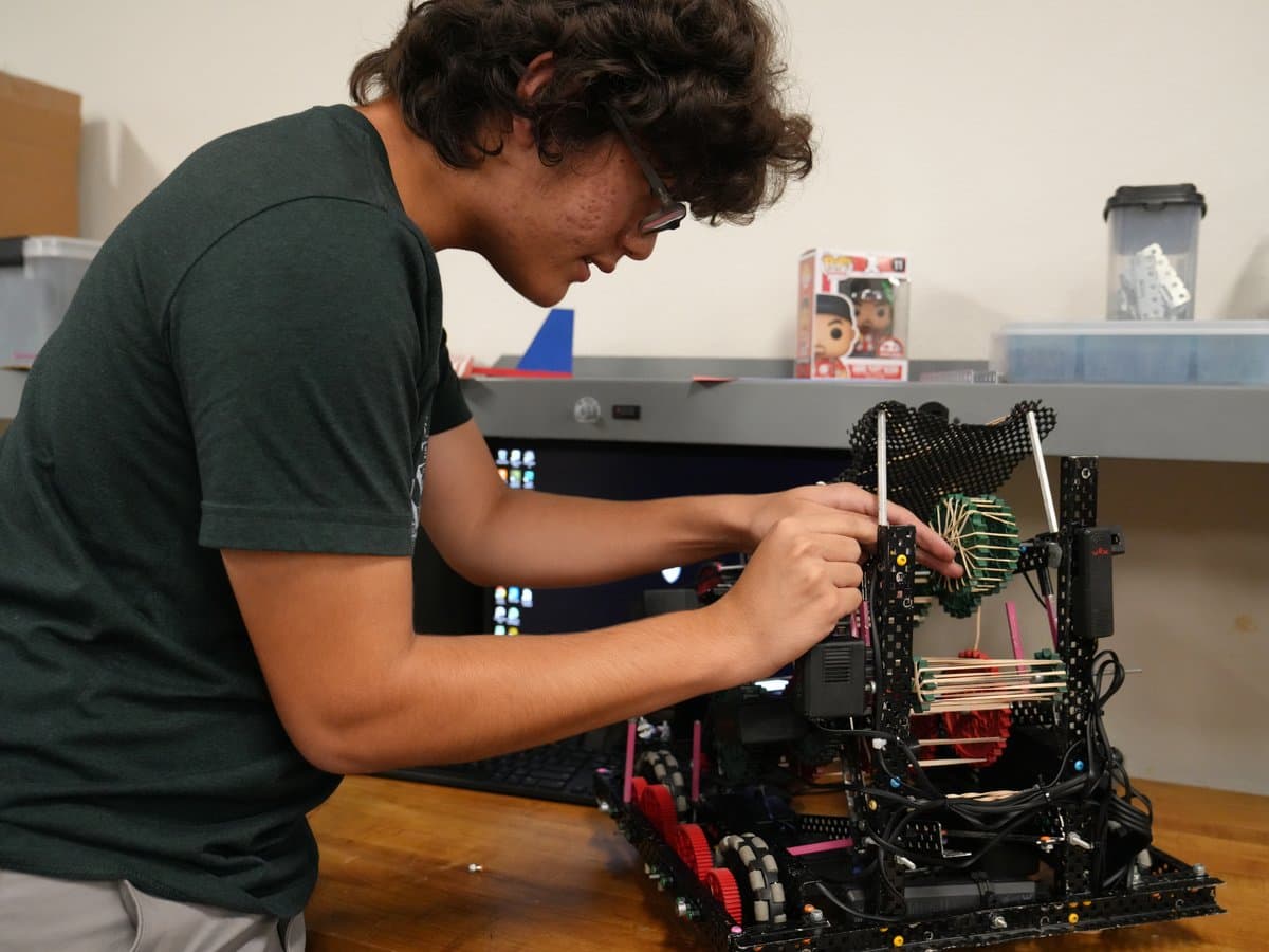 A Madison Highland Prep student building and tuning a VEX competition robot