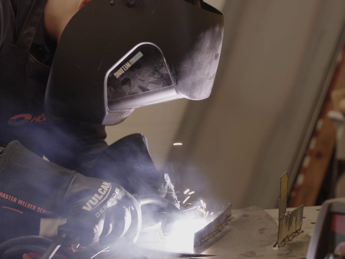 Madison Highland Prep student welding in protective gear in the fabrication shop