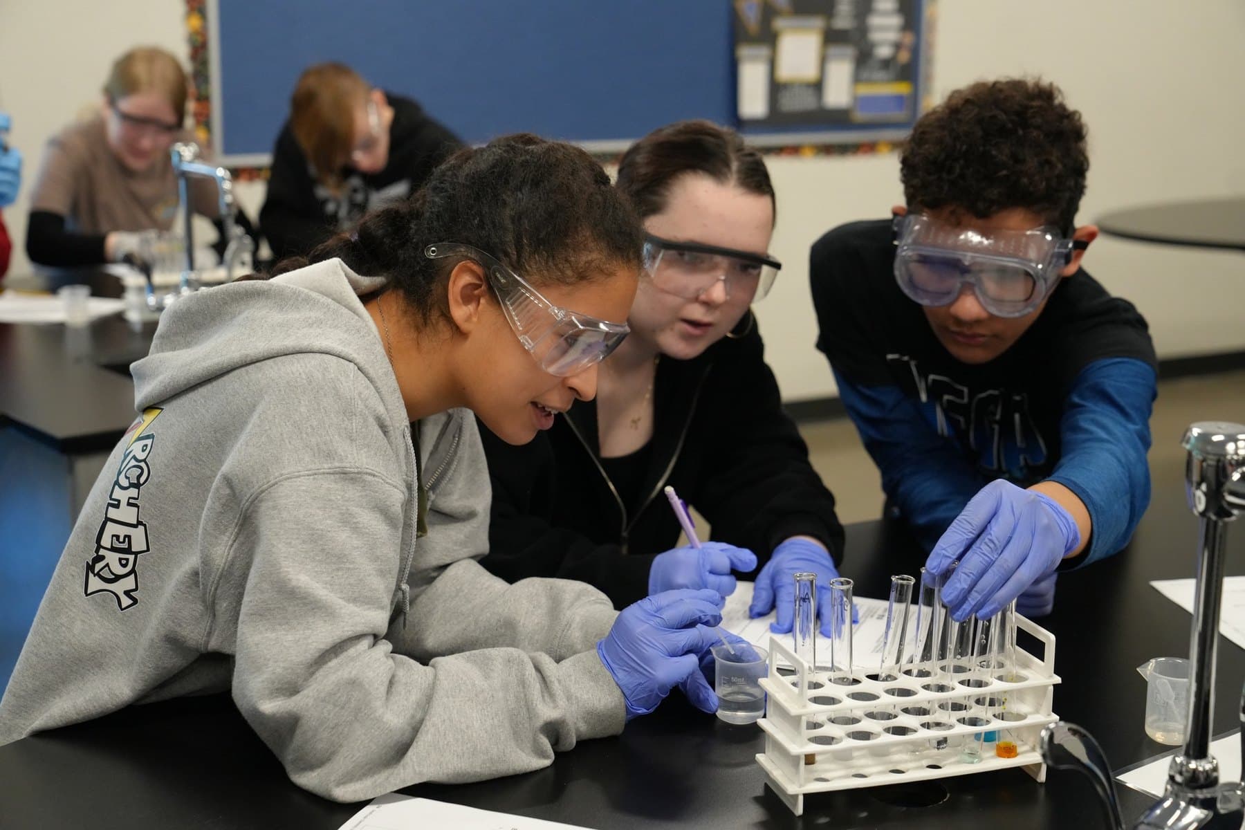 Madison Highland Prep students in safety glasses running a lab experiment
